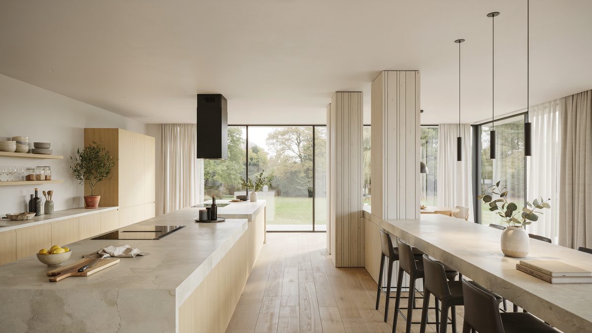 Airy open plan kitchen with white slat posts dividing two pale island counters