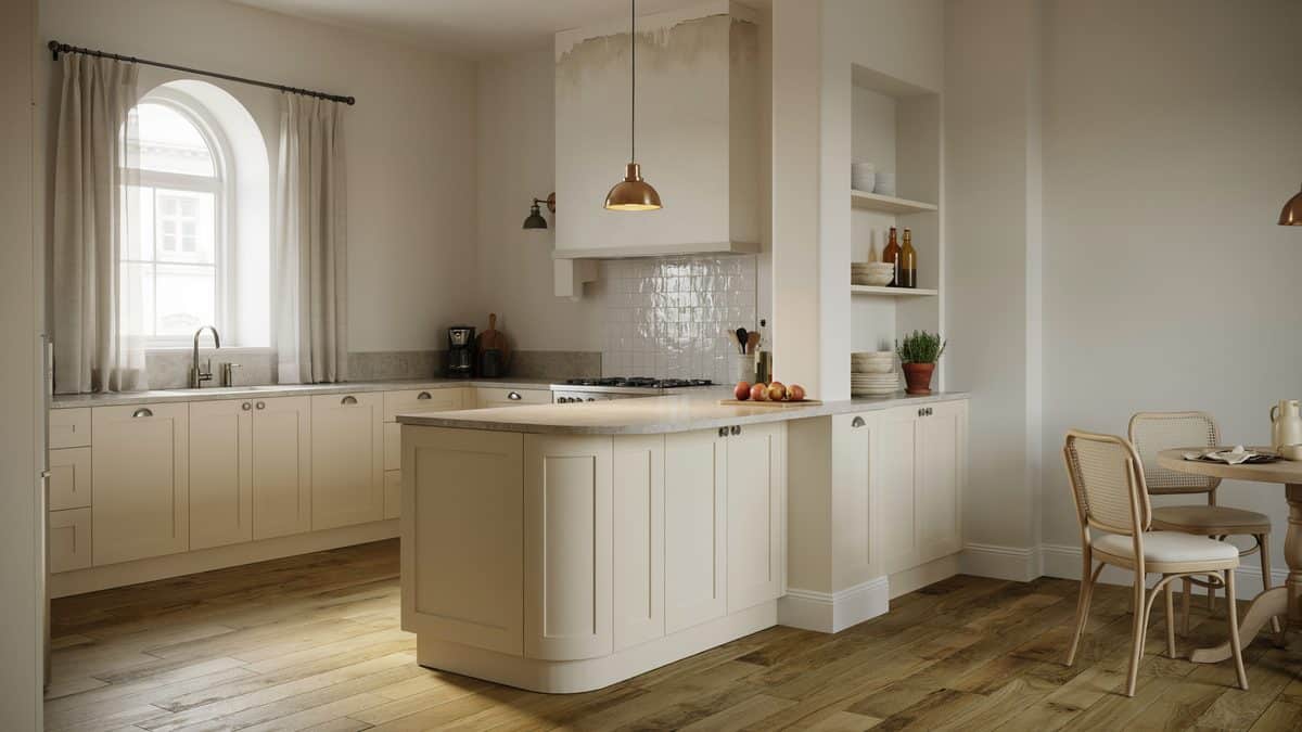 Cream French provincial kitchen with a curved island end and an arched window