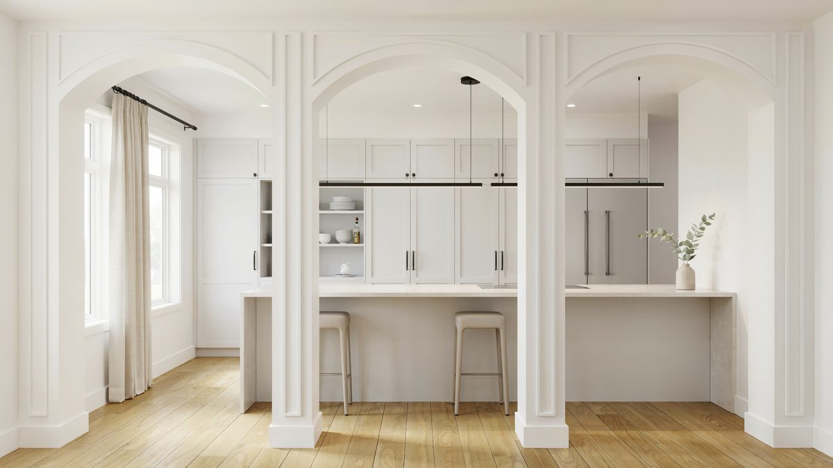 White columns cased into three paneled archways framing a bright kitchen bar