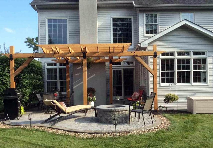 Small backyard patio with fire pit under wood pergola