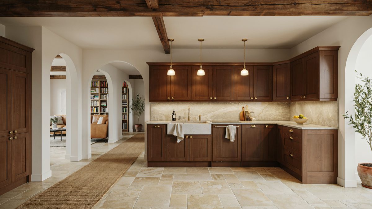 Arched plaster openings frame walnut cabinets above a wide travertine tile floor