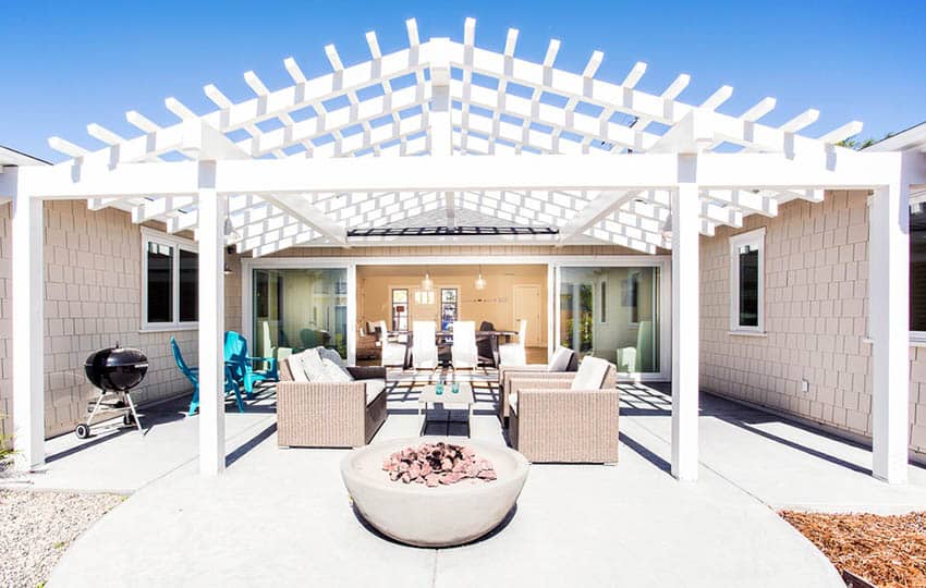 White vaulted ceiling pergola with concrete fire pit