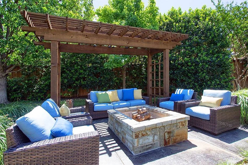 Wood pergola next to fire pit on concrete patio