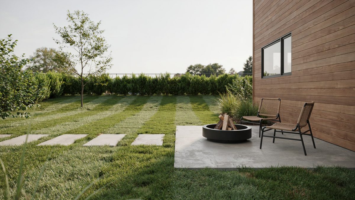 Square concrete stepping stones crossing lawn to a low round fire bowl