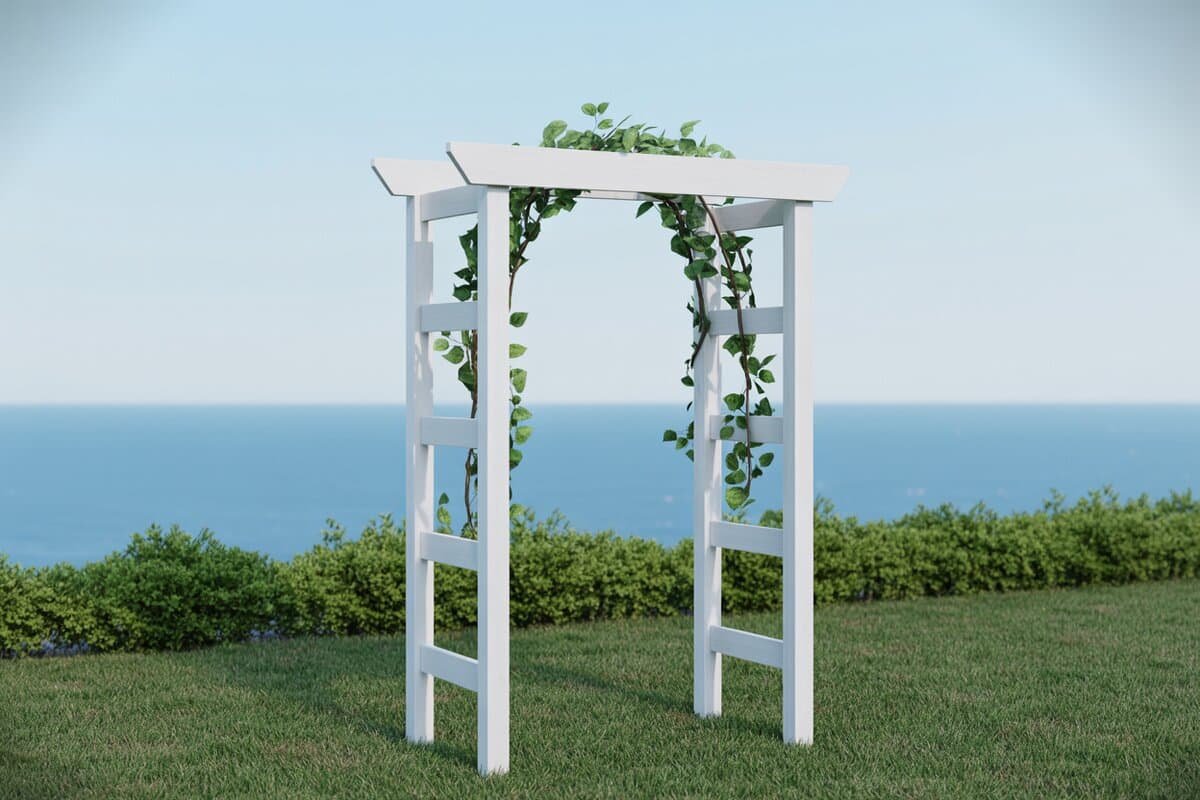 White vinyl arbor with climbing ivy overlooking a calm blue ocean