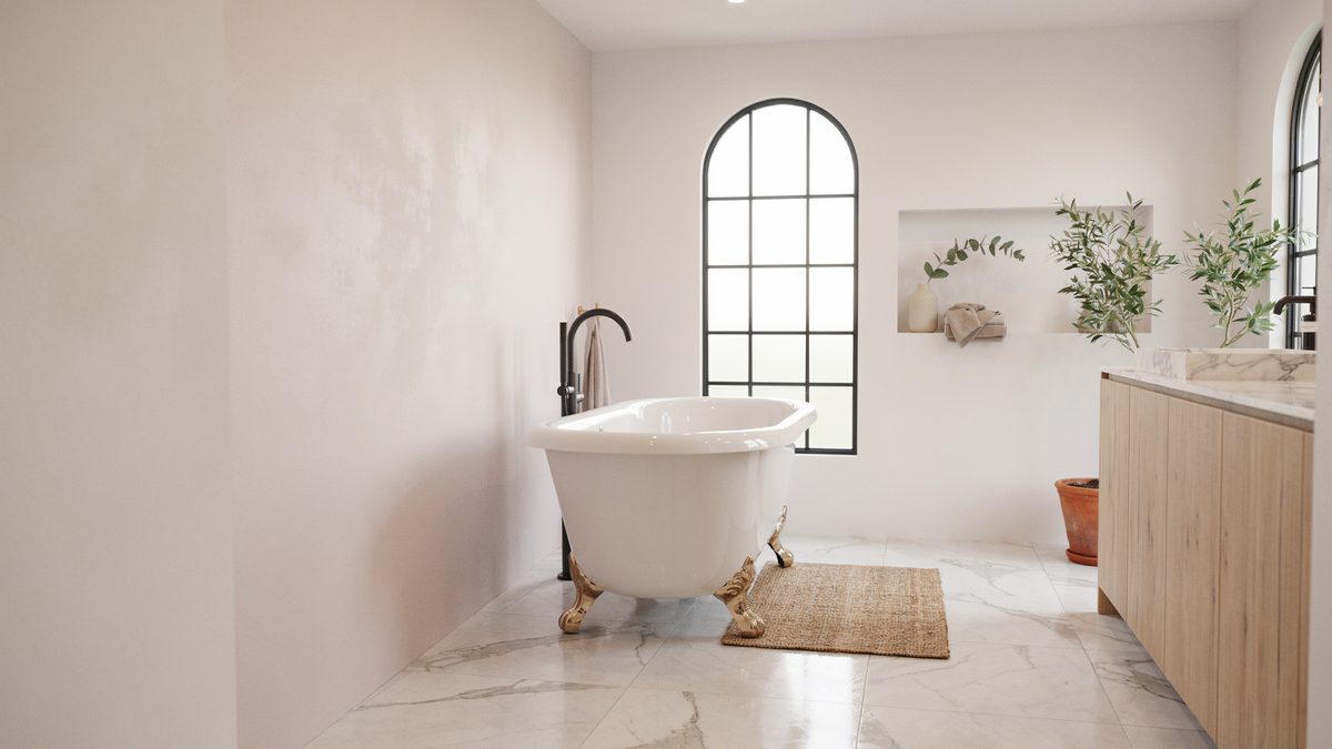 White marble floor with a clawfoot tub, arched window and soft plaster walls