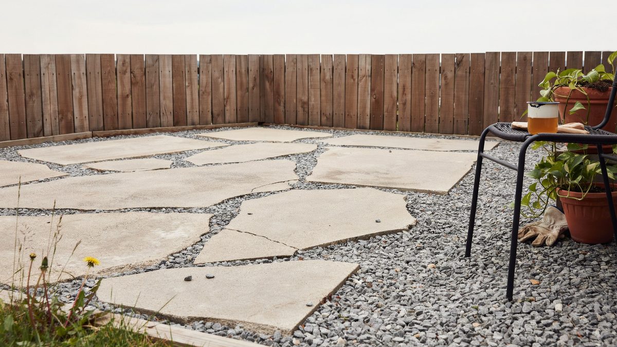 Broken concrete pieces set in gravel forming a recycled patio corner