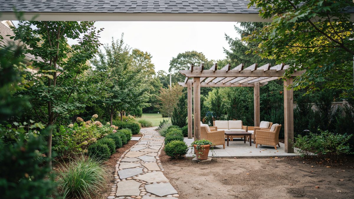 River rock and flagstone path leading to a pergola seating area