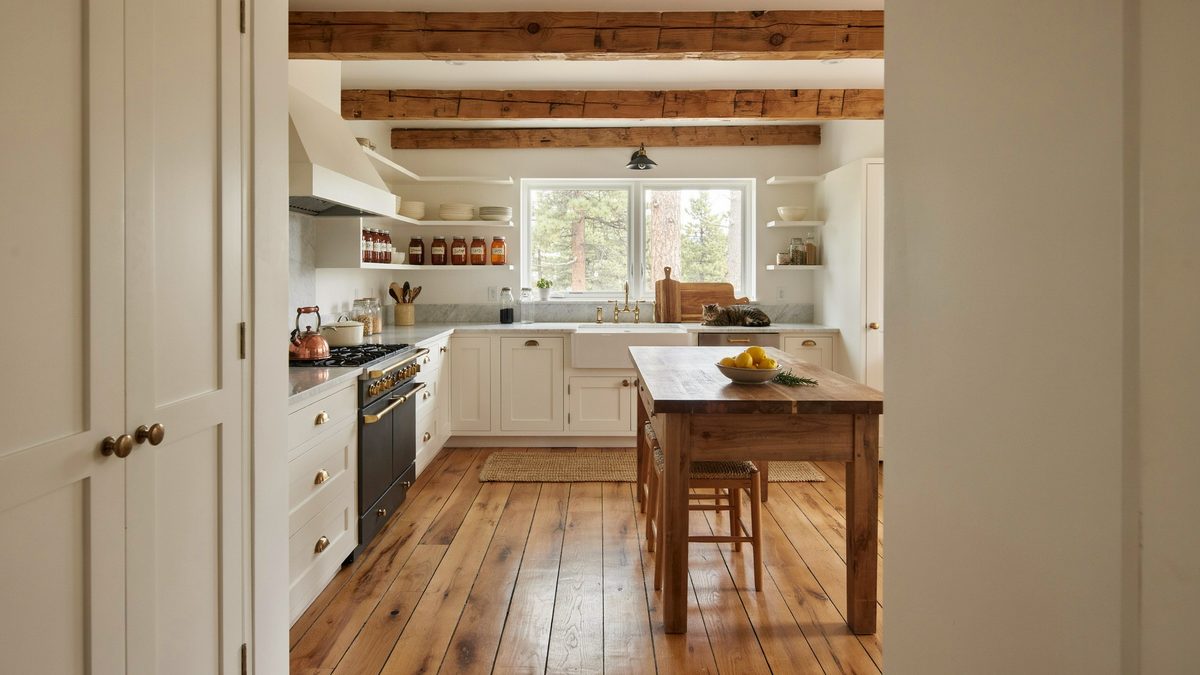 Farmhouse kitchen with knotty pine boards beneath an exposed beam ceiling