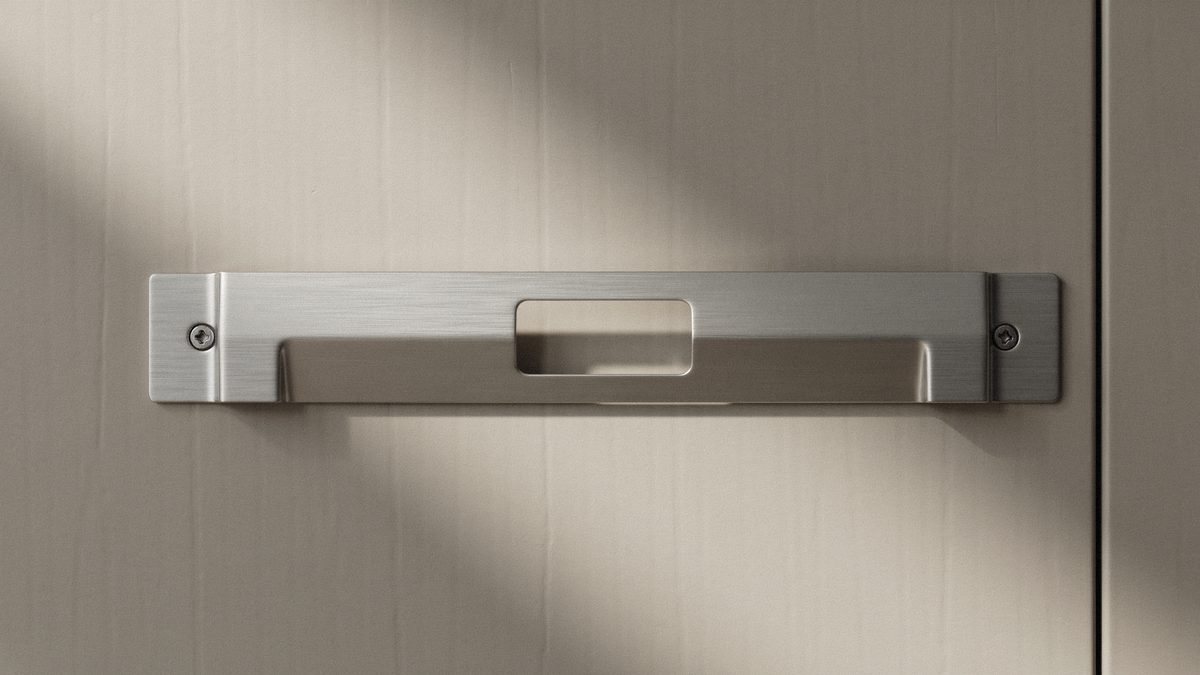 Flat metal bar pull with a rectangular center slot on gray cabinetry