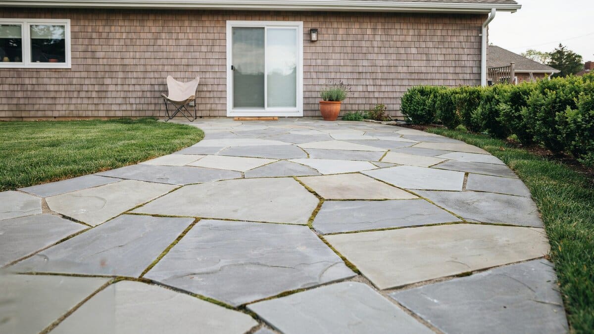 Semi circular slate patio with puzzle fit stones and mossy green joints