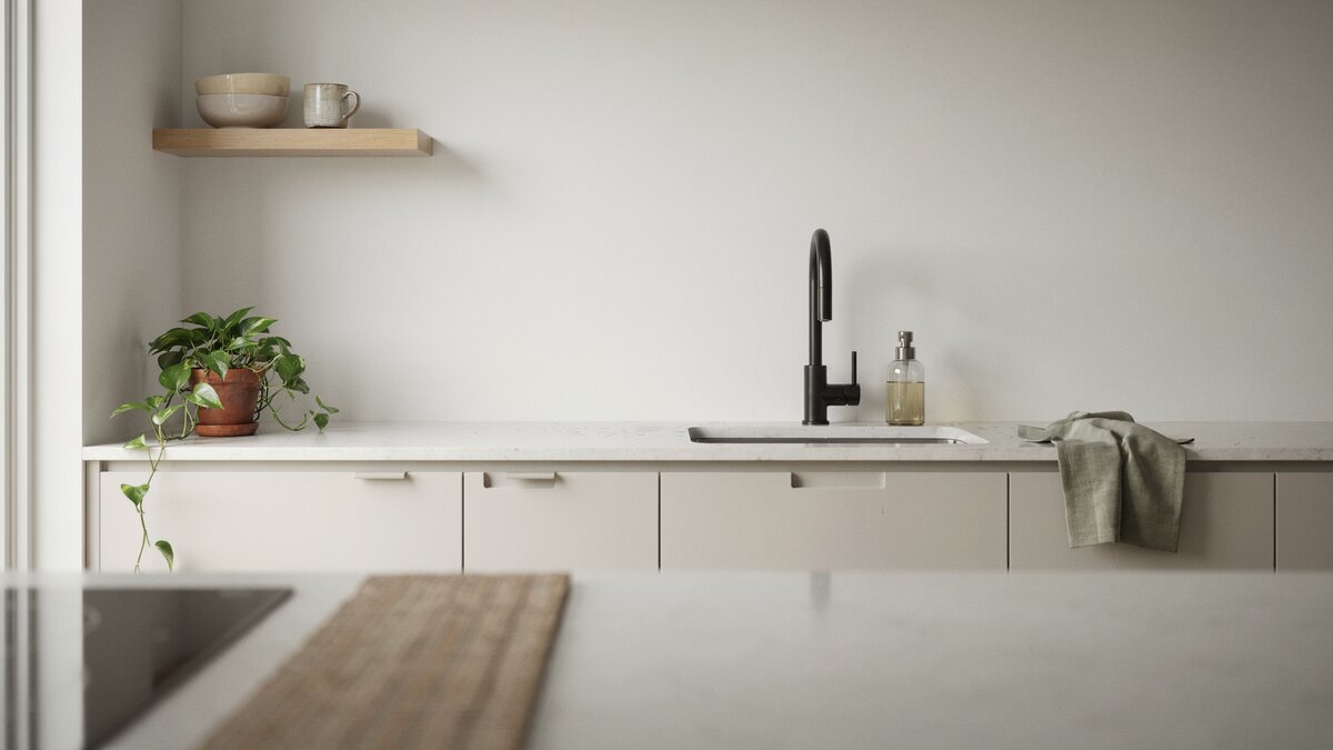 Matte black pull-down faucet on white quartz counter in minimalist kitchen