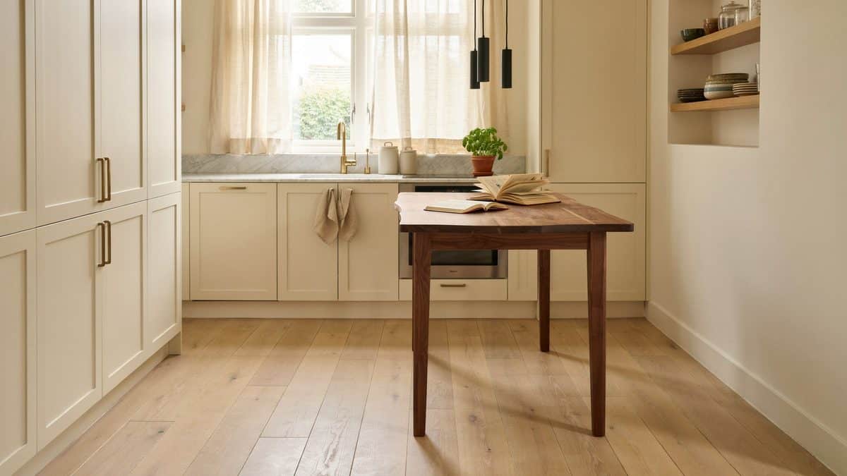 Cream cabinet kitchen with wide European oak boards and a walnut work table