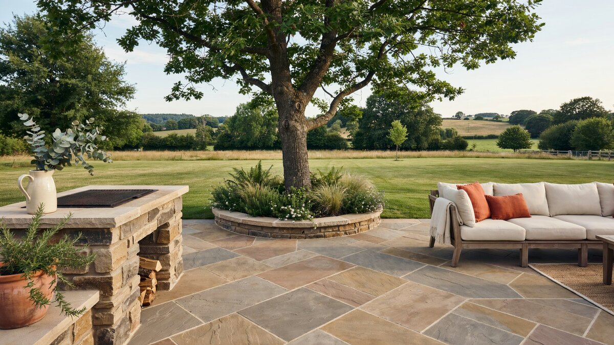 Stone pavers laid around a mature shade tree with an L shaped sofa