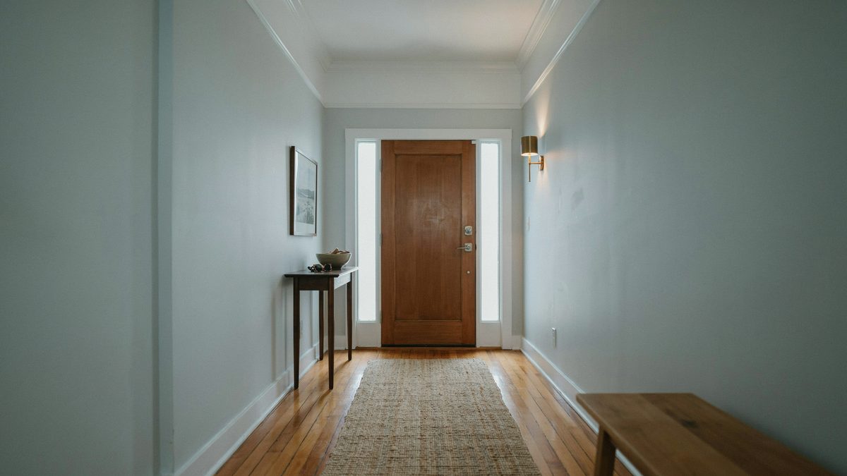 Entry foyer with a wood front door and finished Douglas fir flooring