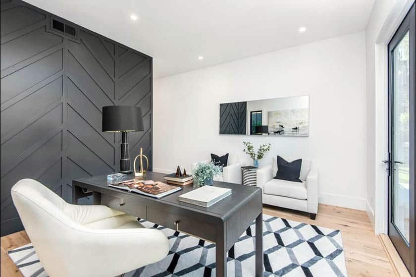 Office space with graphic carpet and black chevron patterned wall design