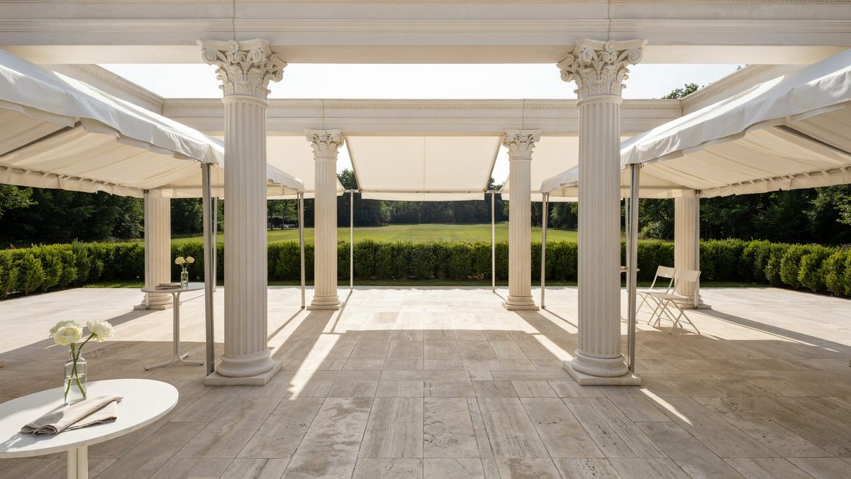 Corinthian column pergola with folding white awnings over a stone terrace