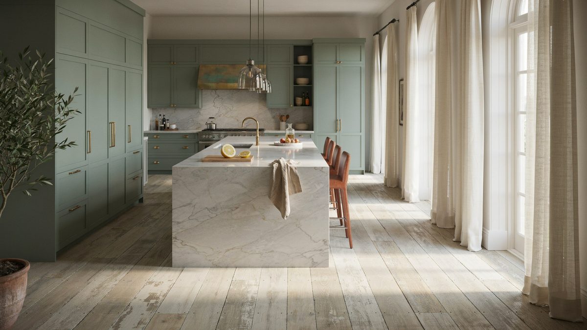 Sage green kitchen with a marble island above distressed white oak planks