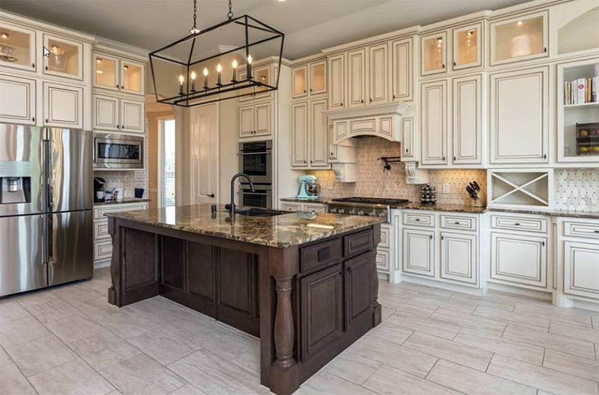 Beautiful kitchen with white glazed distressed maple cabinets and brown island with brown granite counters