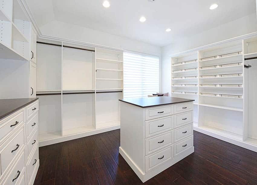 Luxury white panel closet with island double side by side rack and wood floors