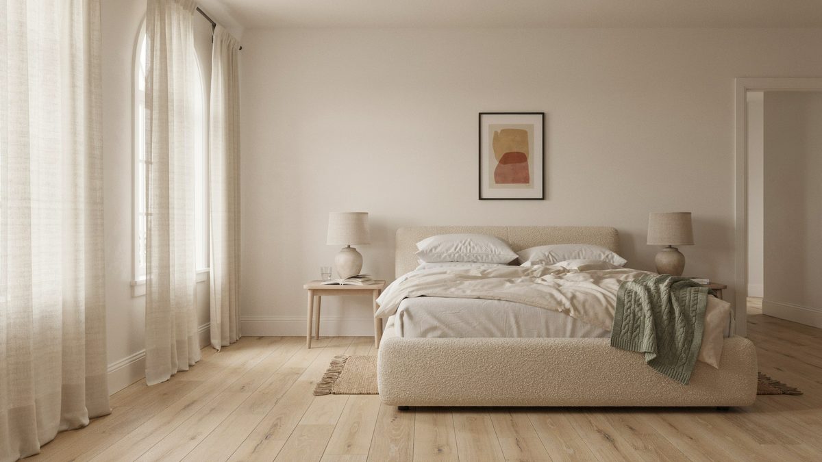 Airy bedroom with pale wood plank flooring and a boucle upholstered bed