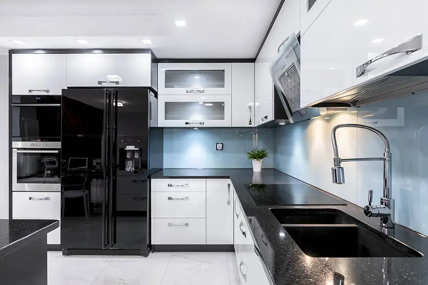 Modern black kitchen cabinets with white doors blue glass backsplash