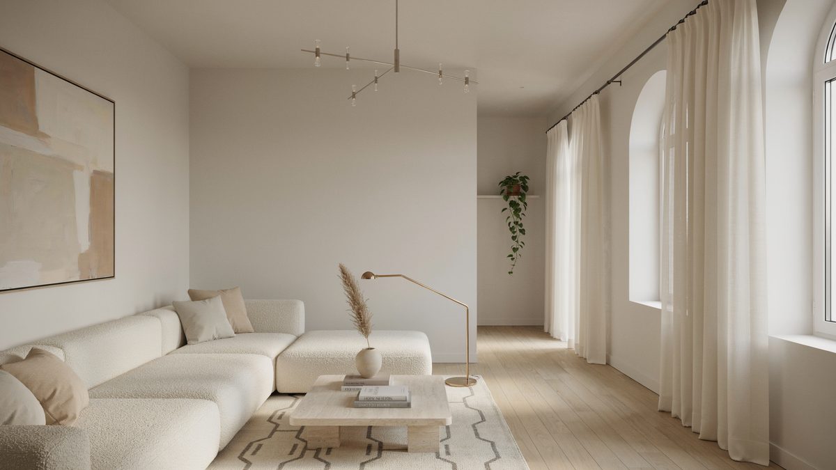Slim crystal fixture above a white boucle sectional in a pale minimalist living room
