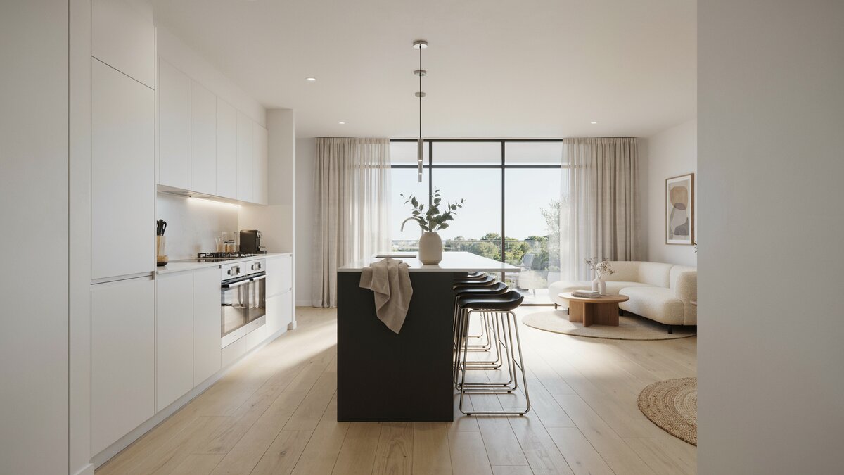 Handleless white cabinetry beside a black island with stools open to the living area