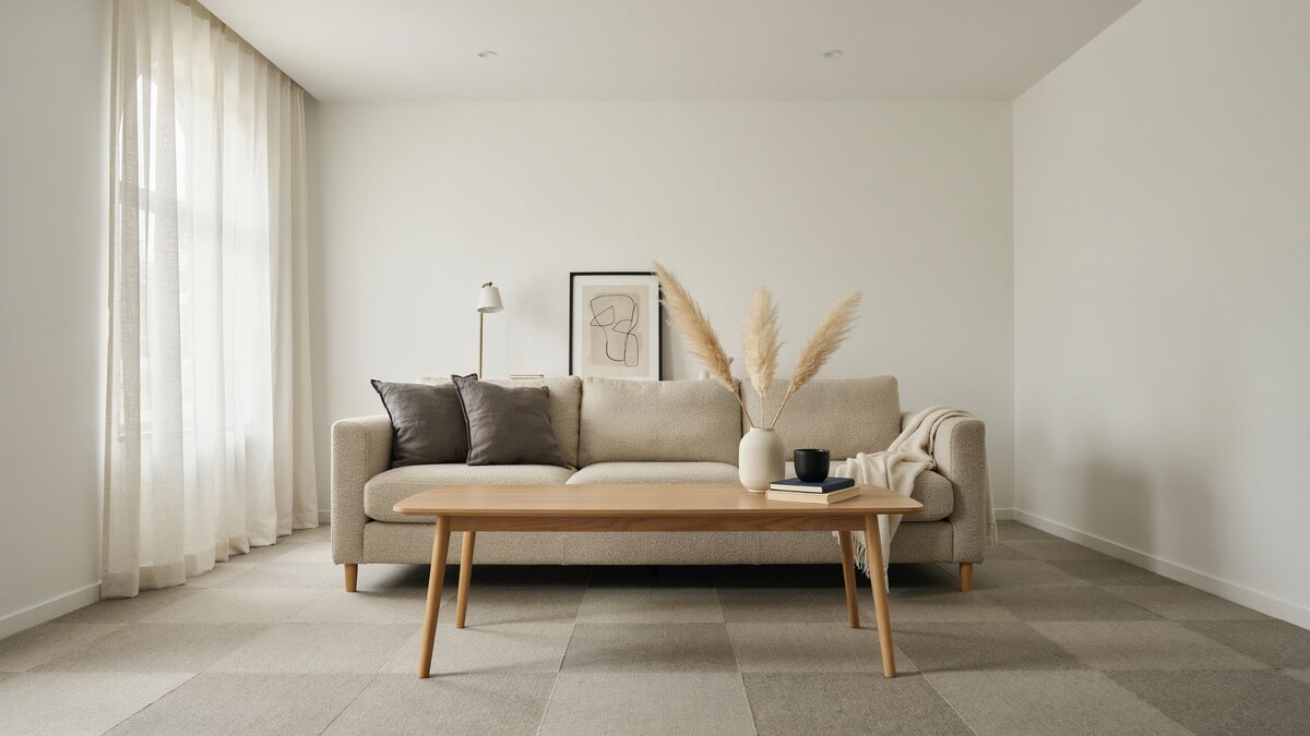 Polyester carpet tiles laid across a modern living room with a low sofa