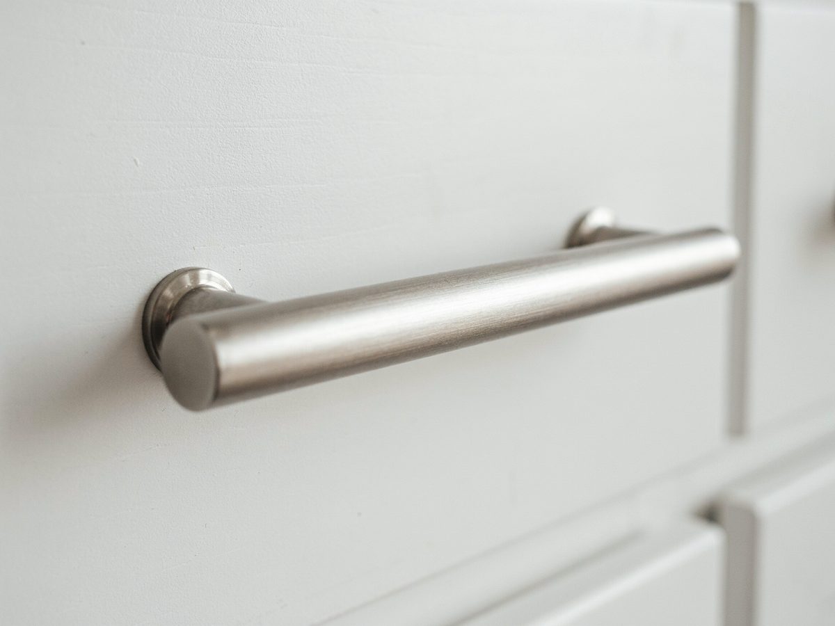 Satin nickel pull with a soft matte sheen on white cabinetry