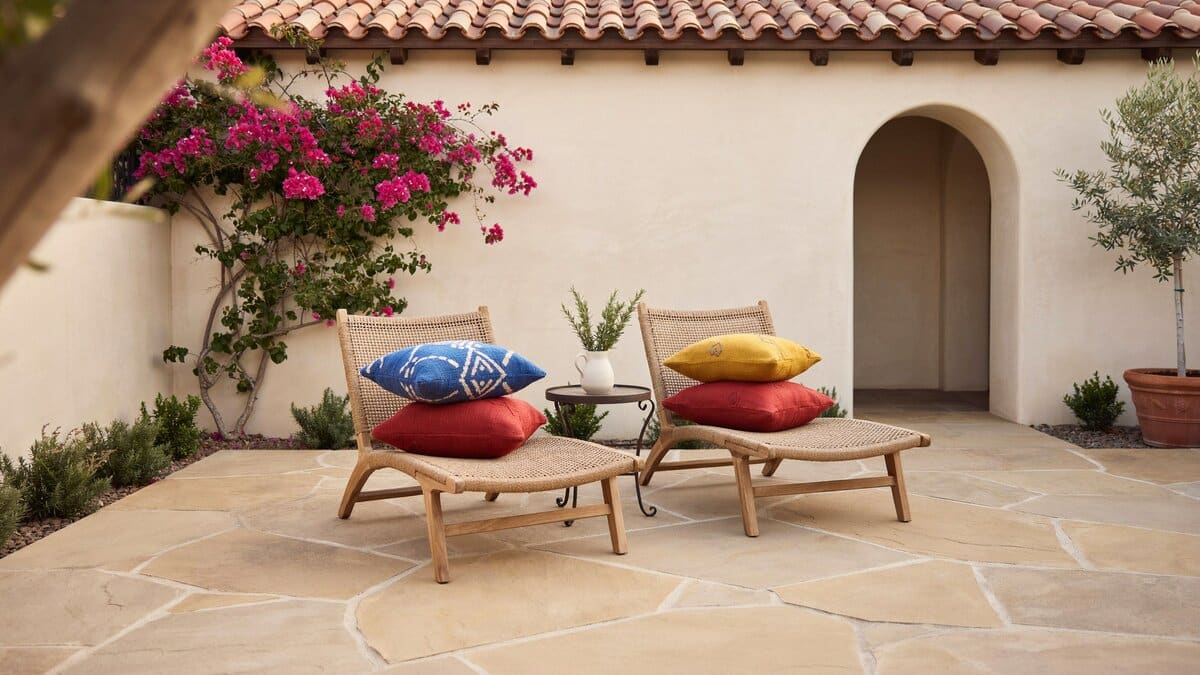 Large tan stone paving matching a stucco wall under a terracotta tile roof