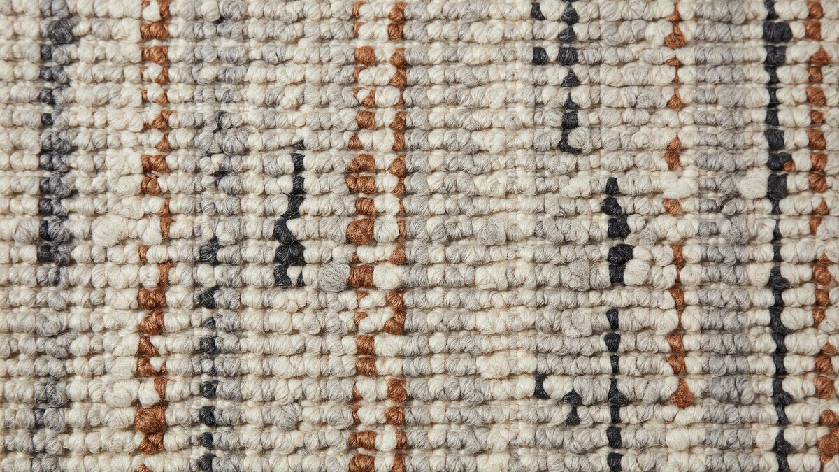 Uncut loop berber carpet with tight even loops in cream and rust