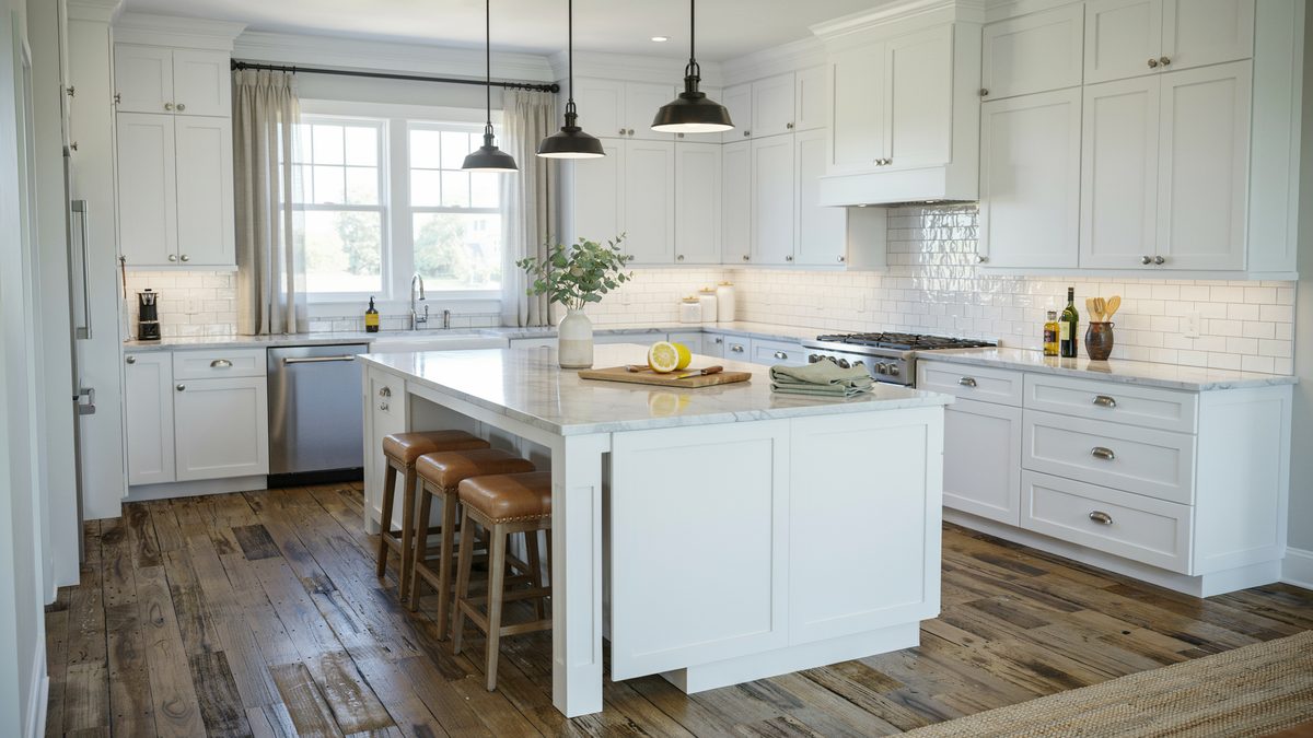 Reclaimed dark distressed planks under a white shaker kitchen with black barn pendants