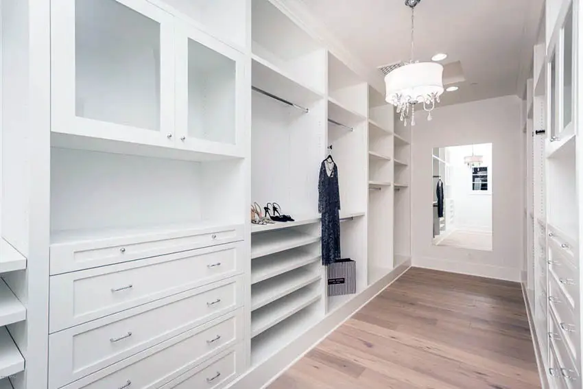 Walk in closet design with built in shoe rack and drum chandelier