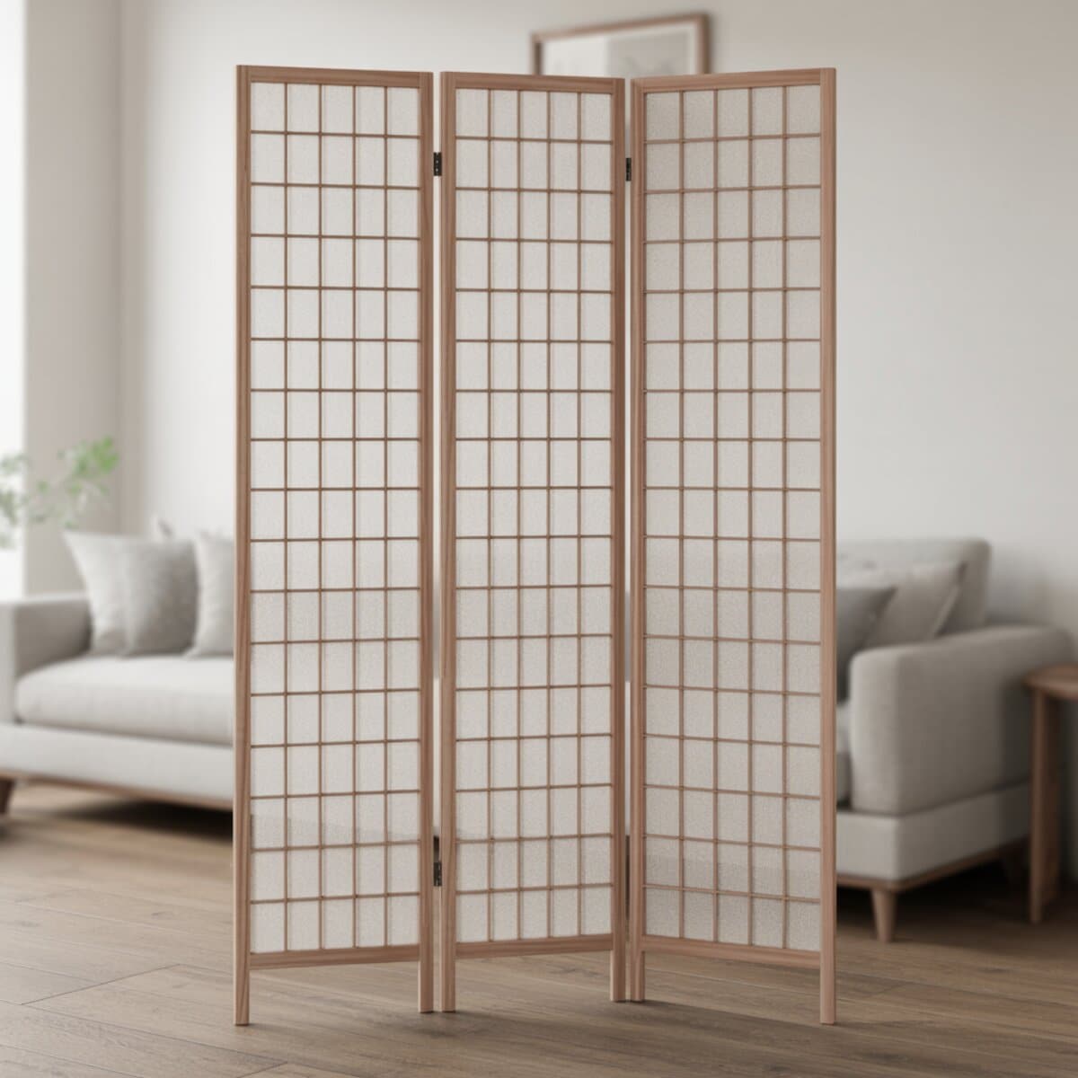 Three panel wood shoji screen with grid lattice standing before a pale sofa