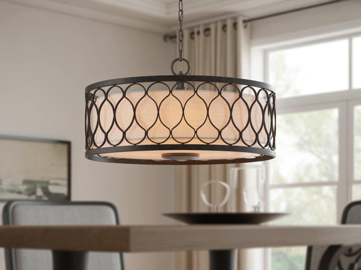 Dark iron lattice drum pendant with linen inner shade above a dining table