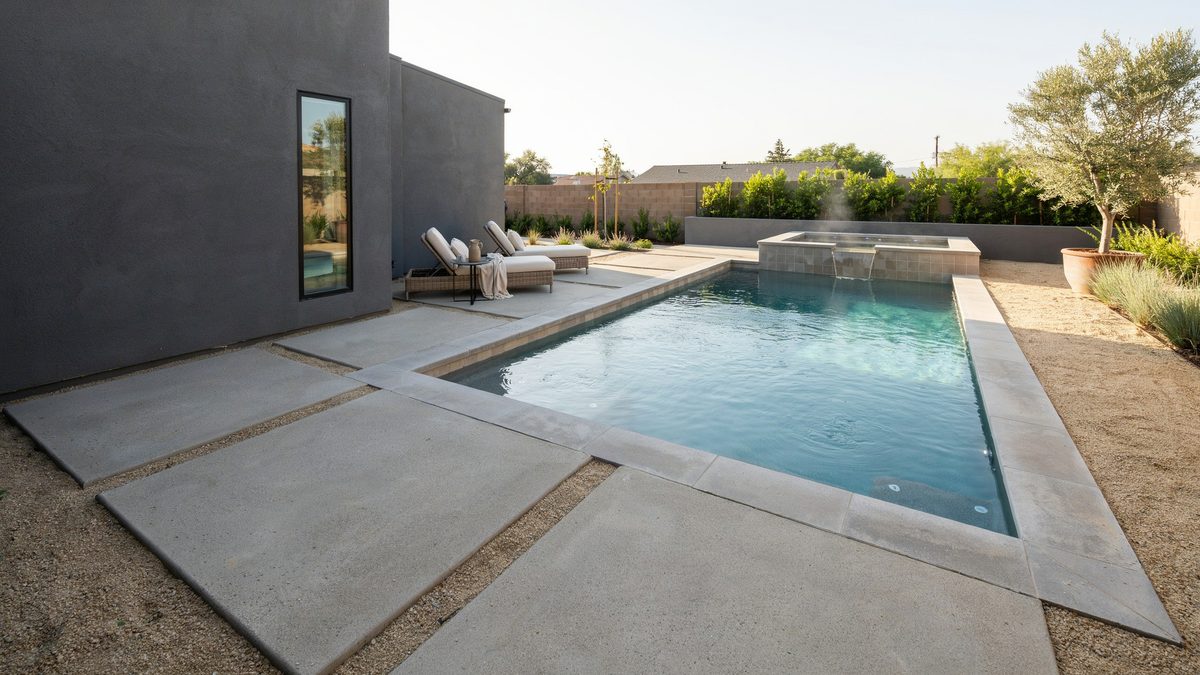 Modern backyard with gravel and concrete pads, pool and elevated spa