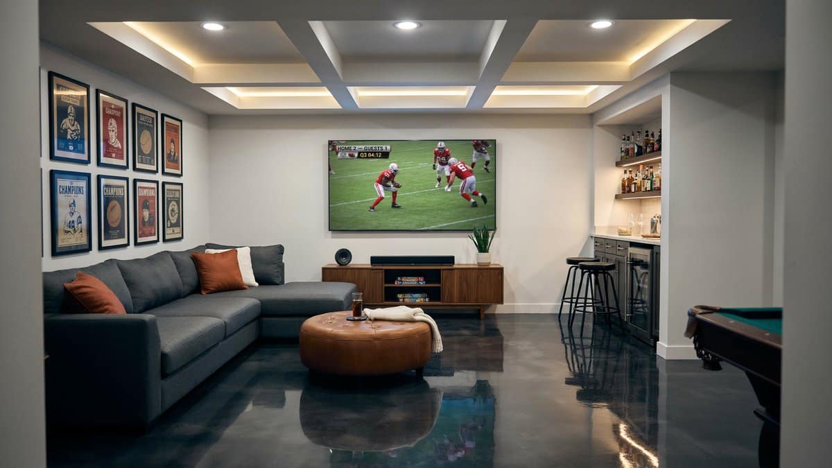 Glossy black epoxy floor reflecting a coffered ceiling and pool table