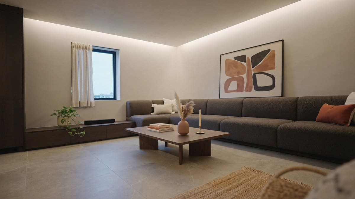 Large format porcelain tile fronting built in wrap around wall couches