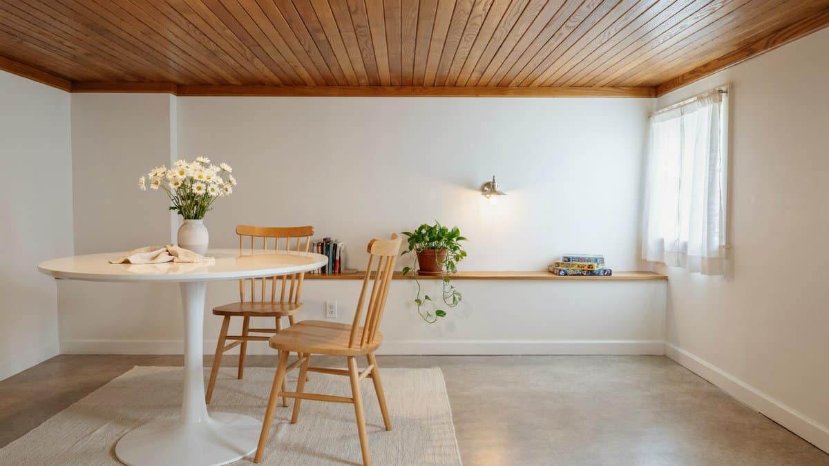 Cream linoleum sheet floor in a bright room with slatted wood ceiling