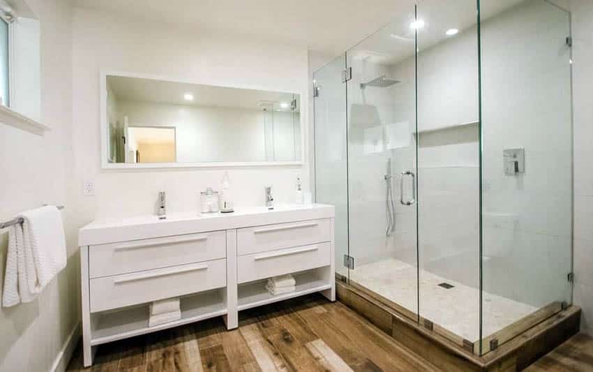 Bathroom with modern vanity and two sinks with glass shower