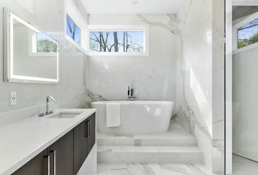 Bathroom with white quartz countertop vanity tub on pedestal