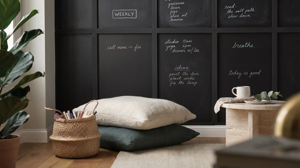 Chalkboard squares painted across two walls of a living room corner nook