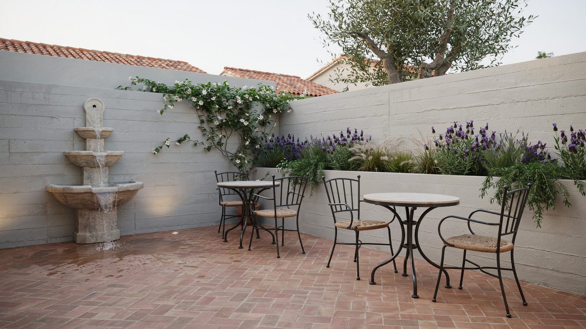 Concrete walled patio with stepped stone water fountain and built in planters