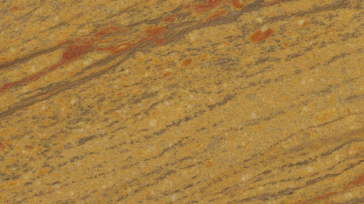 Madura Gold granite slab with warm amber yellow base, bold rust red streaks and diagonal brown veining across the surface