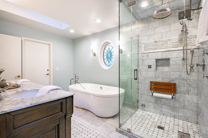 Master bathroom with marble tile shower, rainshower head and freestanding freeform tub