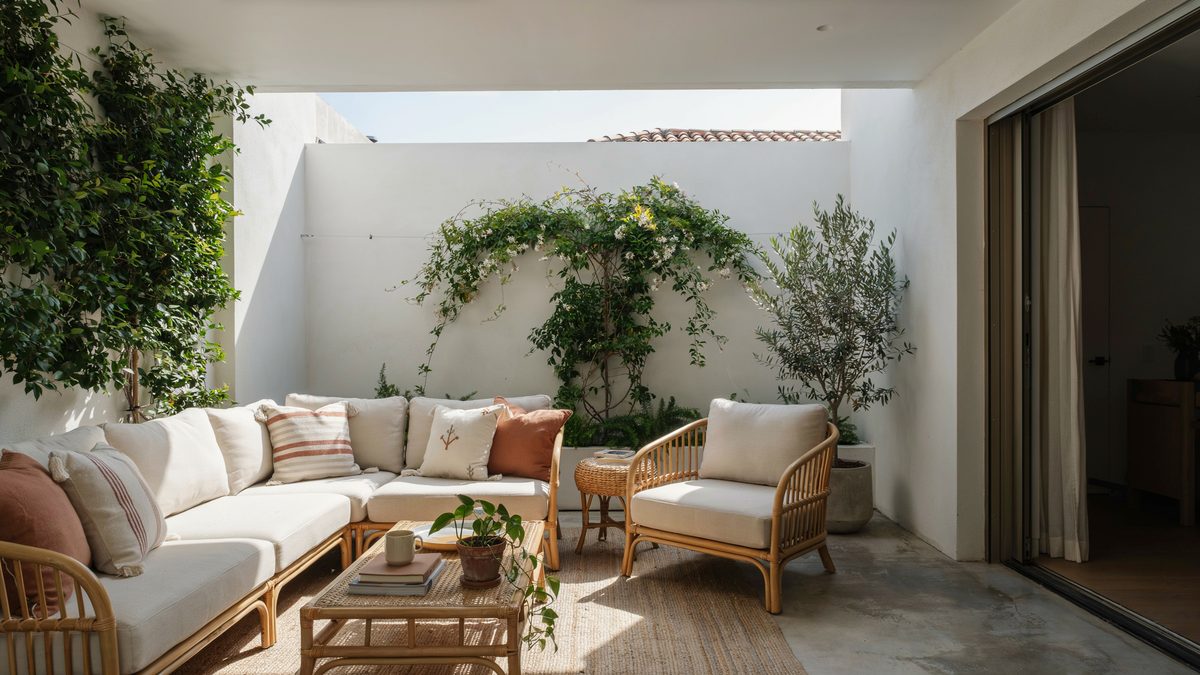 Atrium courtyard patio with bent rattan seating, cream cushions and a fountain