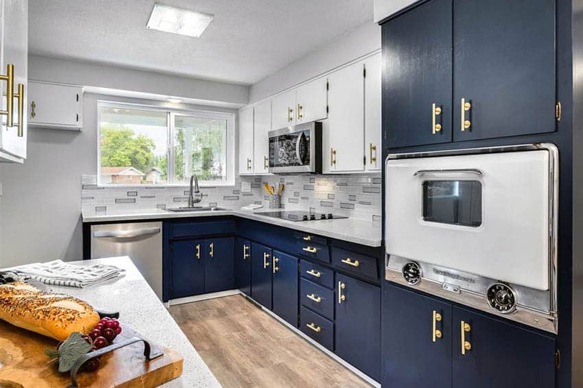 Mid-century modern galley kitchen with navy blue cabinets and white countertops