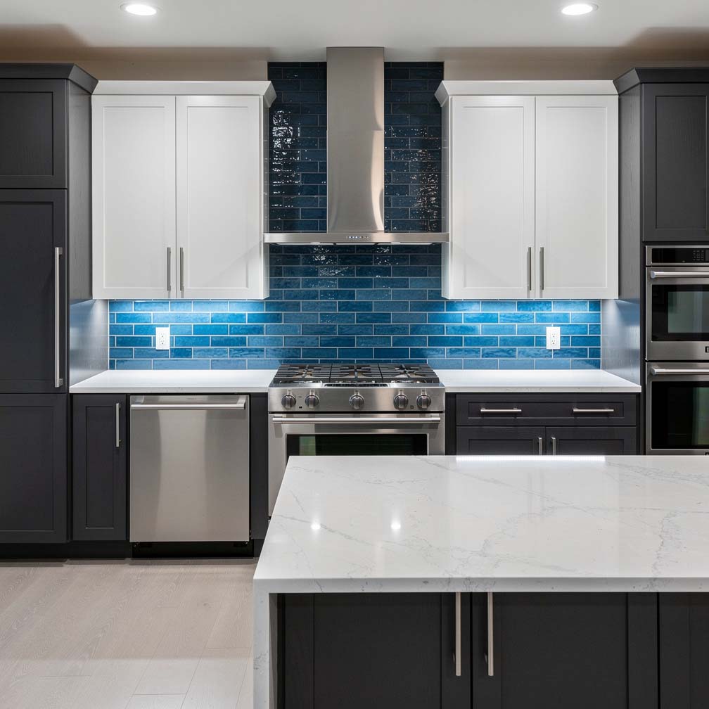 modern kitchen features a blue glass backsplash that looks great paired with white and dark cabinetry.
