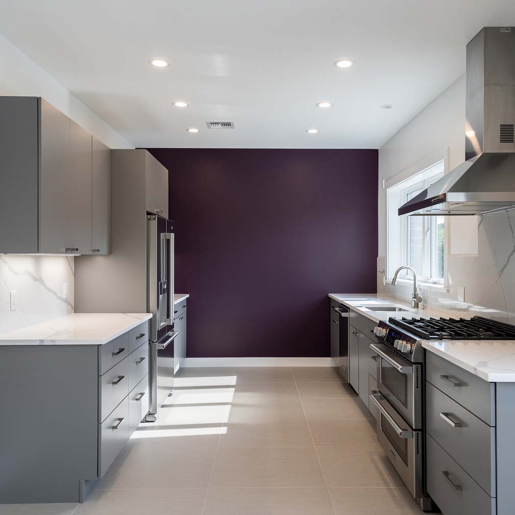 modern kitchen is full of character, with its gray cabinets and furniture contrasting against a bright purple statement